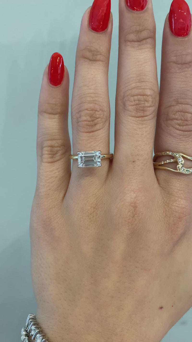 caption:Shown with emerald cut diamond in mixed metal setting