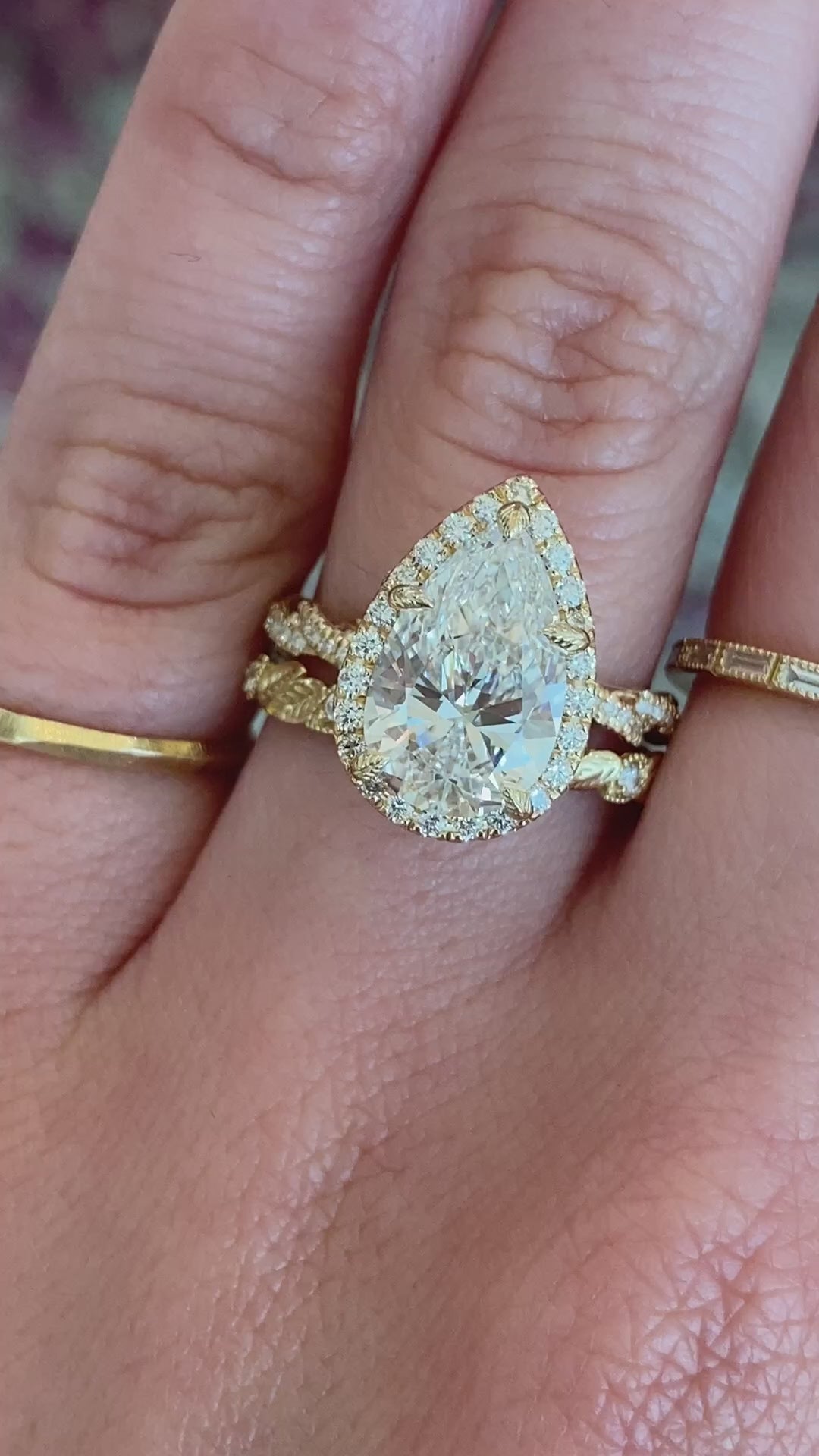 caption:Shown with 3ct pear diamond paired with Koi wedding band