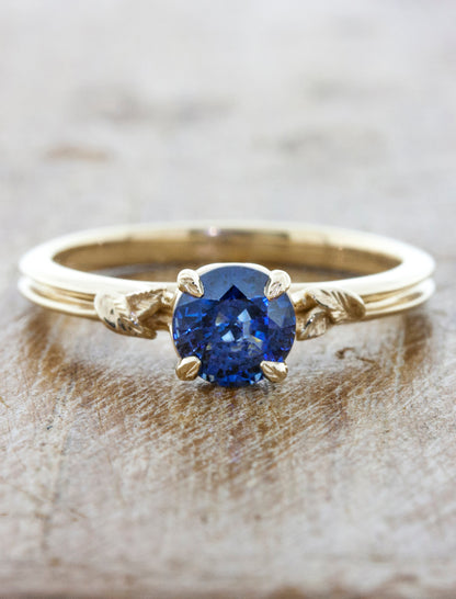 caption:Shown with round blue sapphire in 14k yellow gold