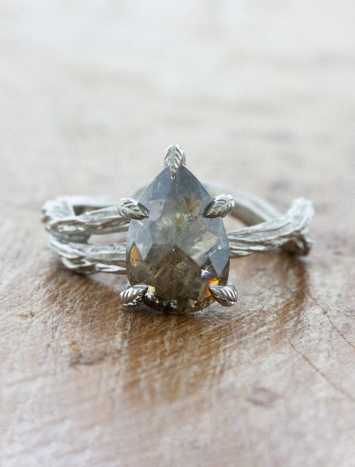 caption:Shown with 1.78ct salt & pepper pear diamond in platinum