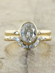 half circle yellow gold wedding bands sprinkled with diamonds. caption:Shown with Daffodil engagement ring