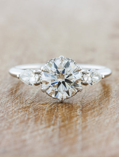 Round diamond with pear shaped side stones Clearance