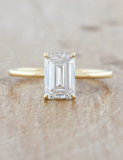 caption:Shown with a 2ct emerald cut in 14k yellow gold