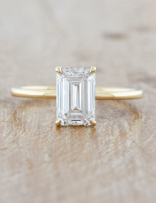 caption:Shown with a 2ct emerald cut in 14k yellow gold