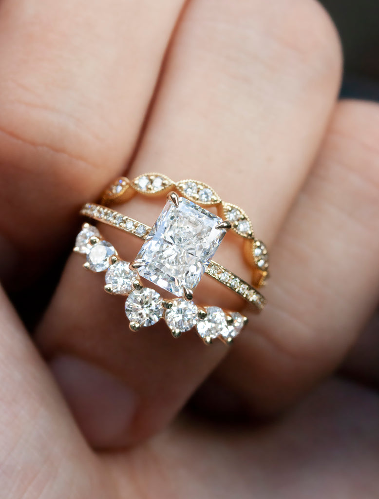 caption:Shown in 14k yellow gold with 2ct center diamond option, paired with Antoinette Large and Natali Curved wedding bands