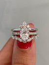 caption:Shown with Laxmie & Marquisa wedding bands in platinum
