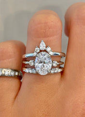 oval solitaire engagement ring shown with two wedding bands