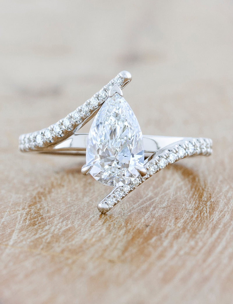caption:Shown with 1.3ct pear diamond in platinum