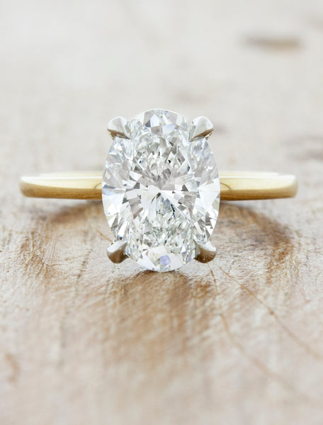 caption:Shown with 2.2ct oval diamond, in 14k yellow band and platinum basket option