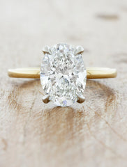caption:Shown with 2.2ct oval diamond, in 14k yellow band and platinum basket option