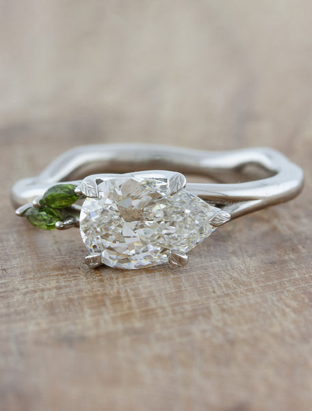 caption:1.20ct pear cut diamond with green sapphire accent stones