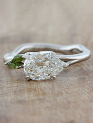 caption:1.20ct pear cut diamond with green sapphire accent stones