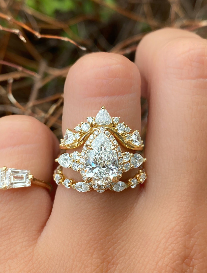 caption:Customized with pear diamond, stacked with Tempest & Sarah wedding bands