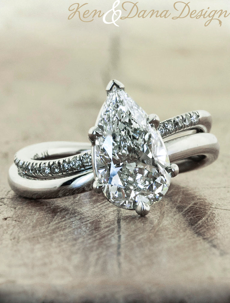 modern pear shaped diamond ring with band;caption:2.09ct. Pear Diamond Platinum paired with Bella wedding band