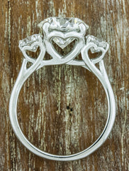 heart shaped setting, three stone diamond ring. caption:Customized with heart shape baskets
