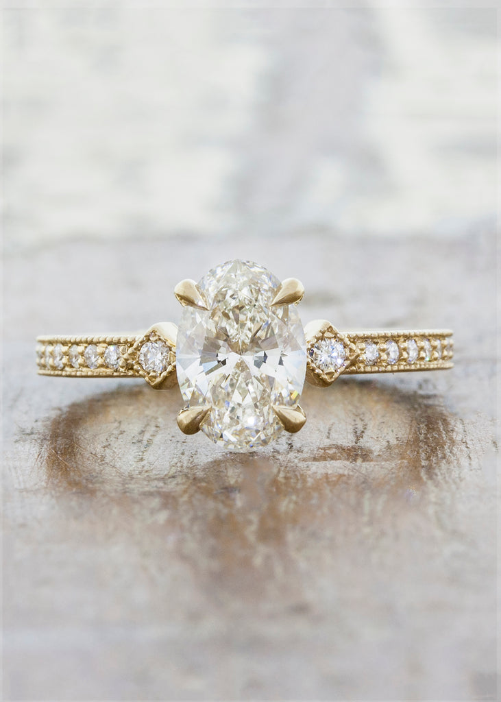 Vintage inspired engagement ring. caption:Customized with a vertically set 0.90ct. Oval Diamond 14k Yellow Gold