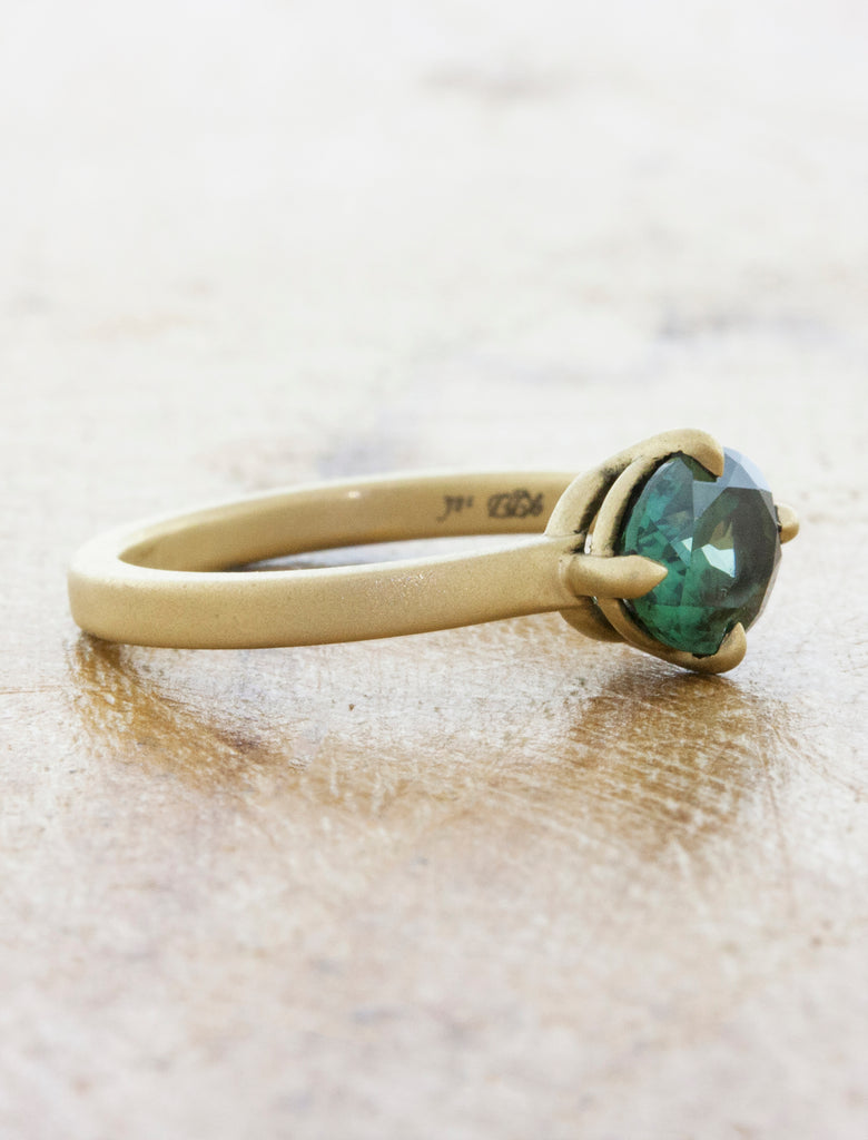 sideways oval sapphire in brushed yellow gold band