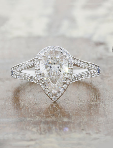 Halo engagement ring with pear shaped diamond and a split band caption: 1.56ct. Pear Diamond Platinum