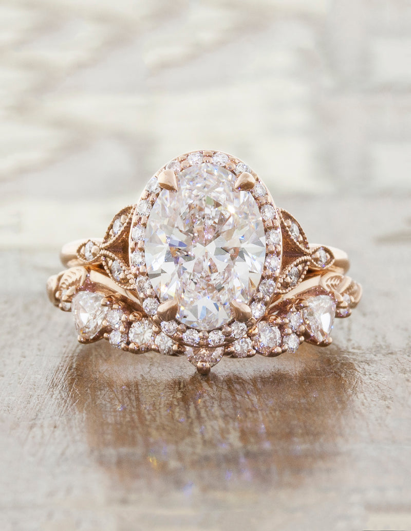 oval solitaire and curved wedding band with trillion diamonds