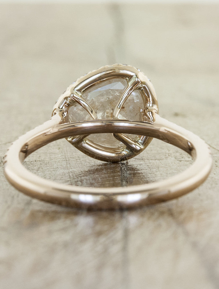 unique engagement ring with pear shaped diamond and a halo in rose gold