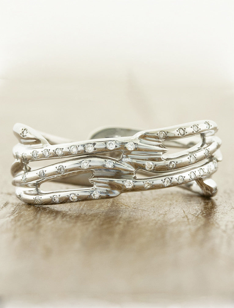 multi strand, split shank diamond accented wedding band. caption:Shown in 14k white gold