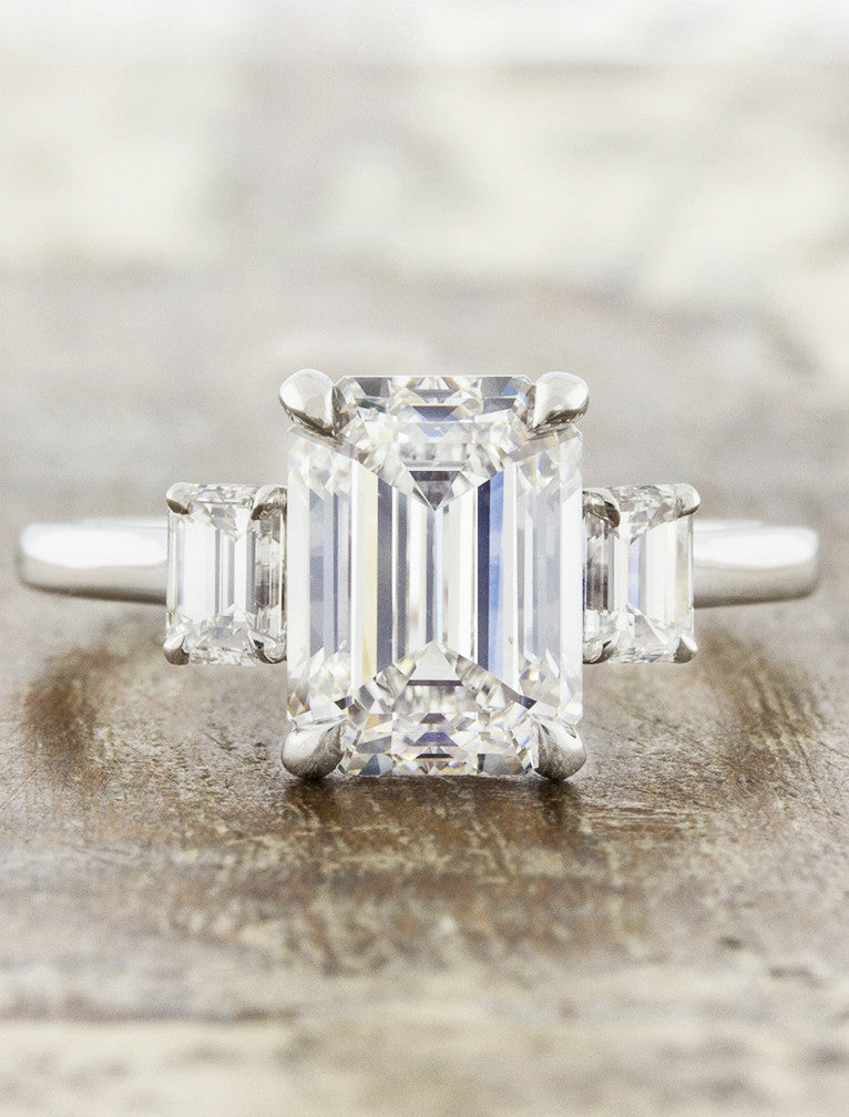 three stone emerald cut diamond engagement ring caption:3ct+ center diamond set with 0.50 tcw side stones
