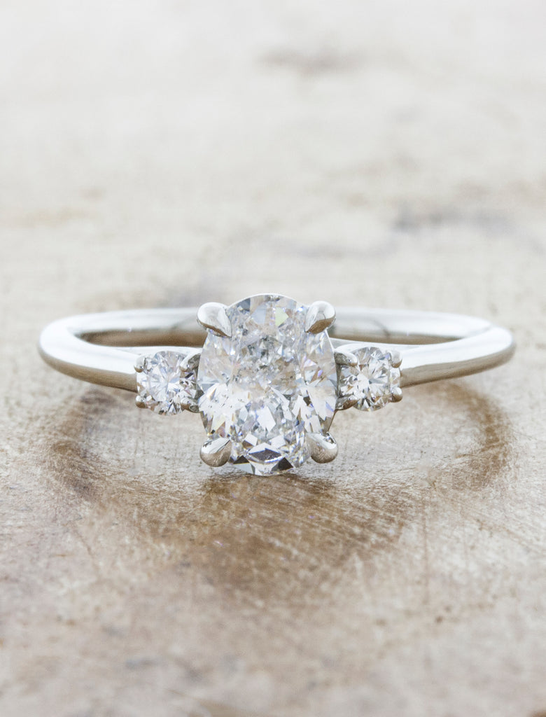 caption:Customized with oval center stone, and smaller side diamonds