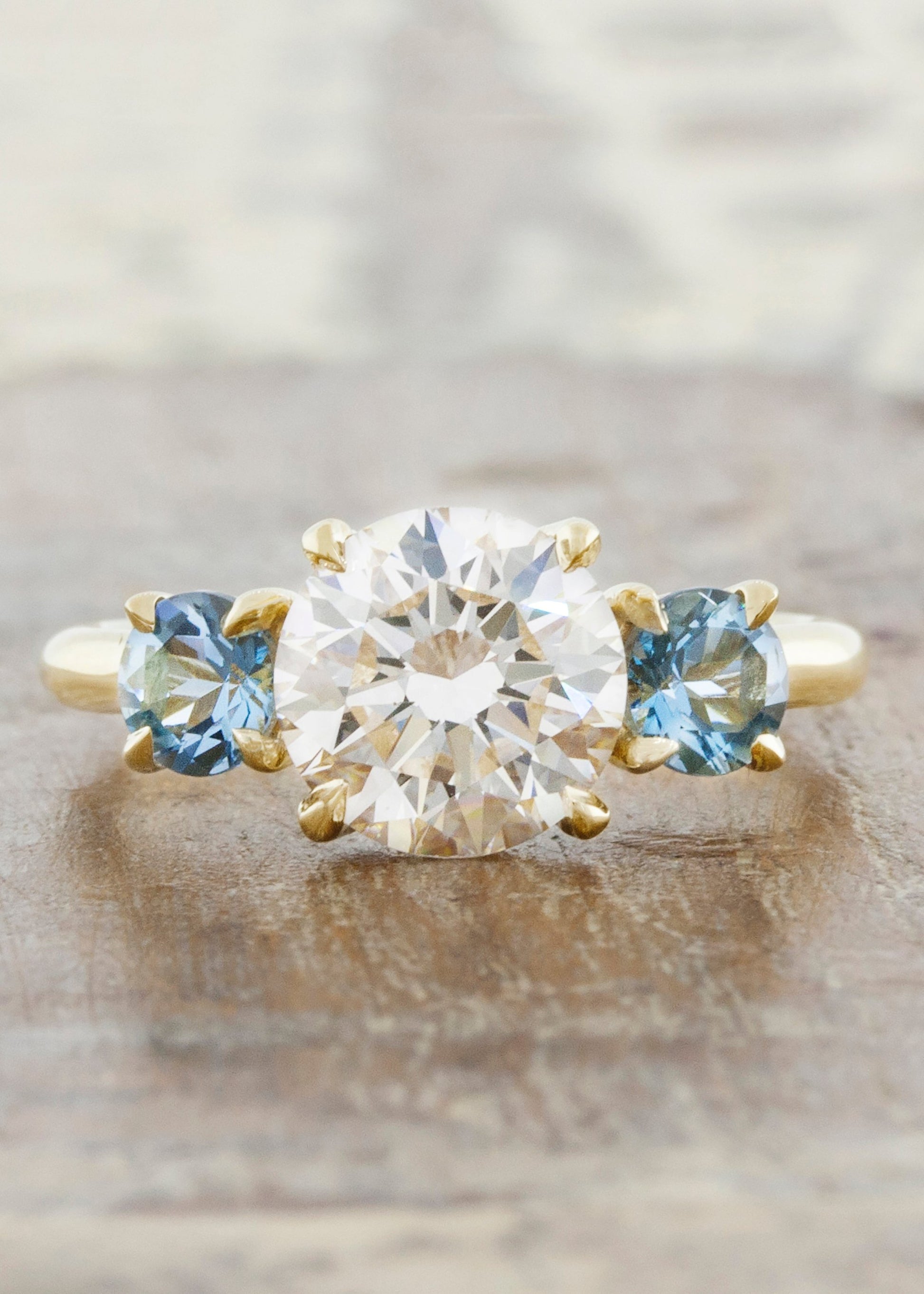 caption:Customized with aquamarine side stones in 14k yellow gold