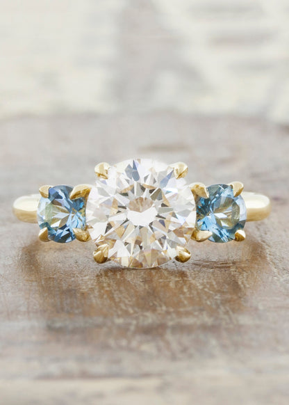 caption:Customized with aquamarine side stones in 14k yellow gold