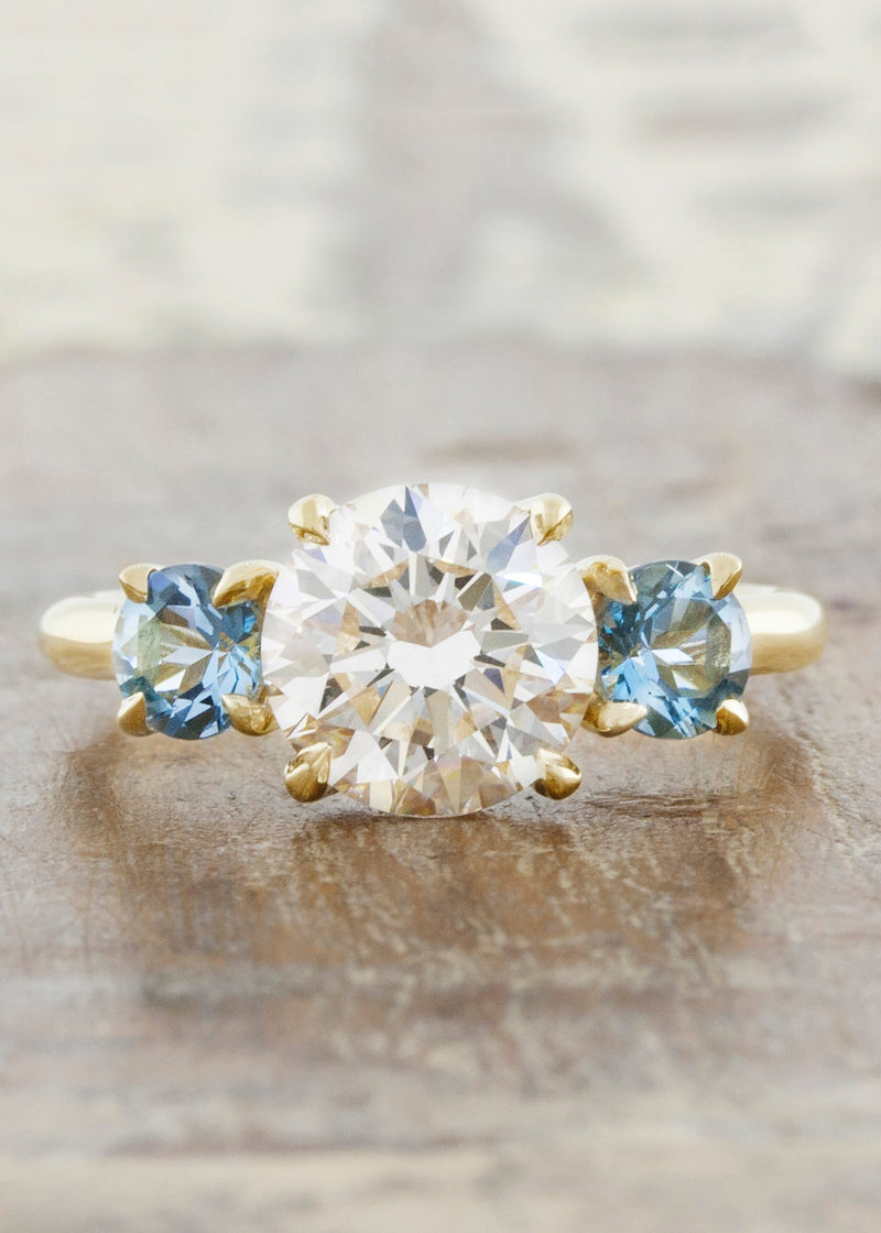 caption:Customized with aquamarine side stones in 14k yellow gold