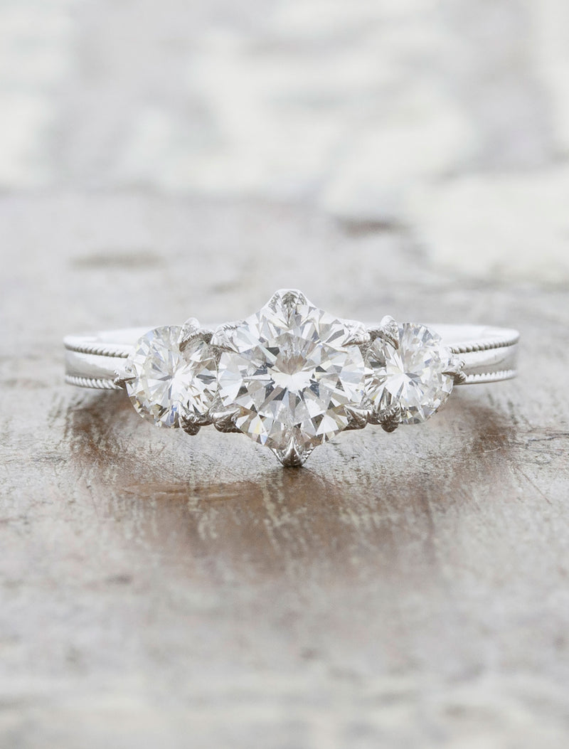 caption:Shown with 5.85mm round diamond center stone & 4mm side stones in platinum