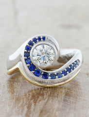 Asymmetrical Band Ring with Sapphire & Diamonds. caption:Shown with a 0.75ct center diamond