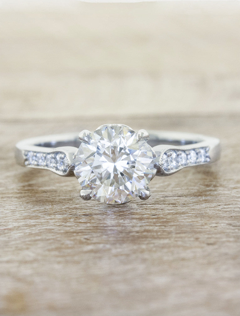 conflict free round diamond solitaire ring in an intricate band