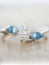 caption:Shown with 0.75ct round diamond, customized with aquamarine side stones 