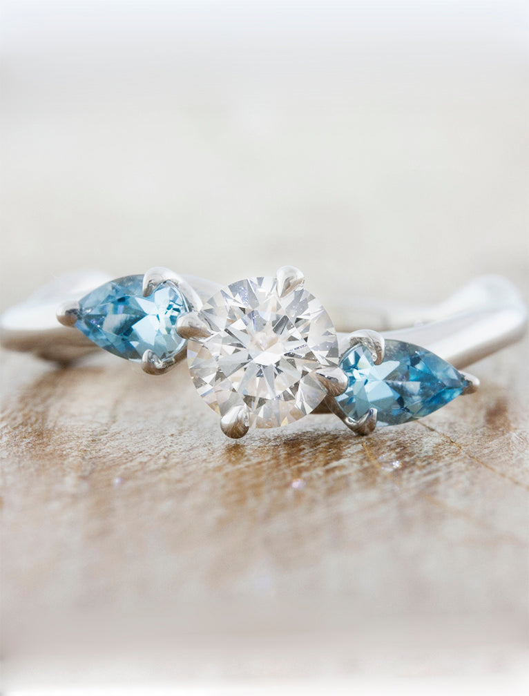 caption:Shown with 0.75ct round diamond, customized with aquamarine side stones 
