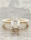 caption:Customized with oval diamond, tapered band, & 4-prong setting in 14k yellow gold