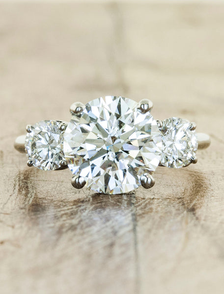 three stone diamond engagement ring. caption:Shown with a 2.22ct center diamond