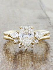 countoured prong set diamond wedding band. caption:Shown in yellow gold with the Permelia engagement ring