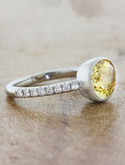 yellow oval cut sapphire set sideways in 2mm pave band