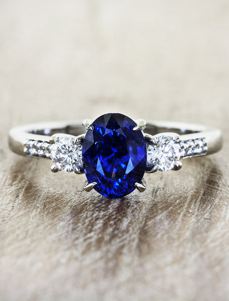 three stone diamond & sapphire engagement ring. caption:Customized with pavé settings on band, and oval center stone