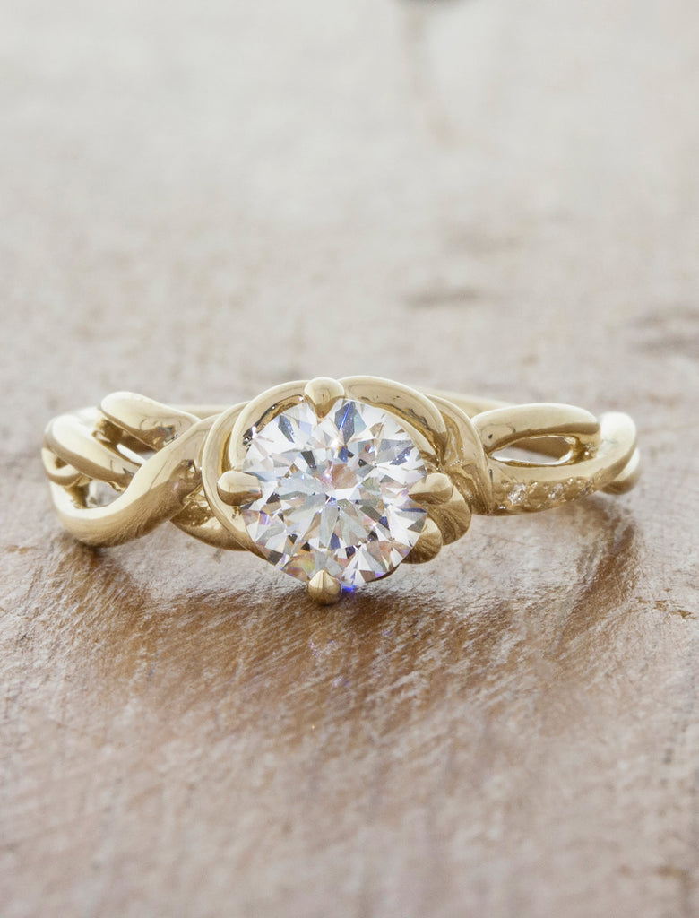 caption:Shown in 14k yellow gold, with an 0.7ct center diamond