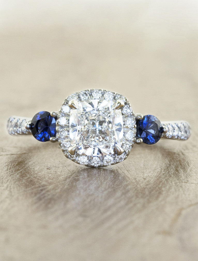 halo cushion cut diamond engagement ring with blue sapphire accents