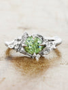 caption:Shown in platinum with green sapphire