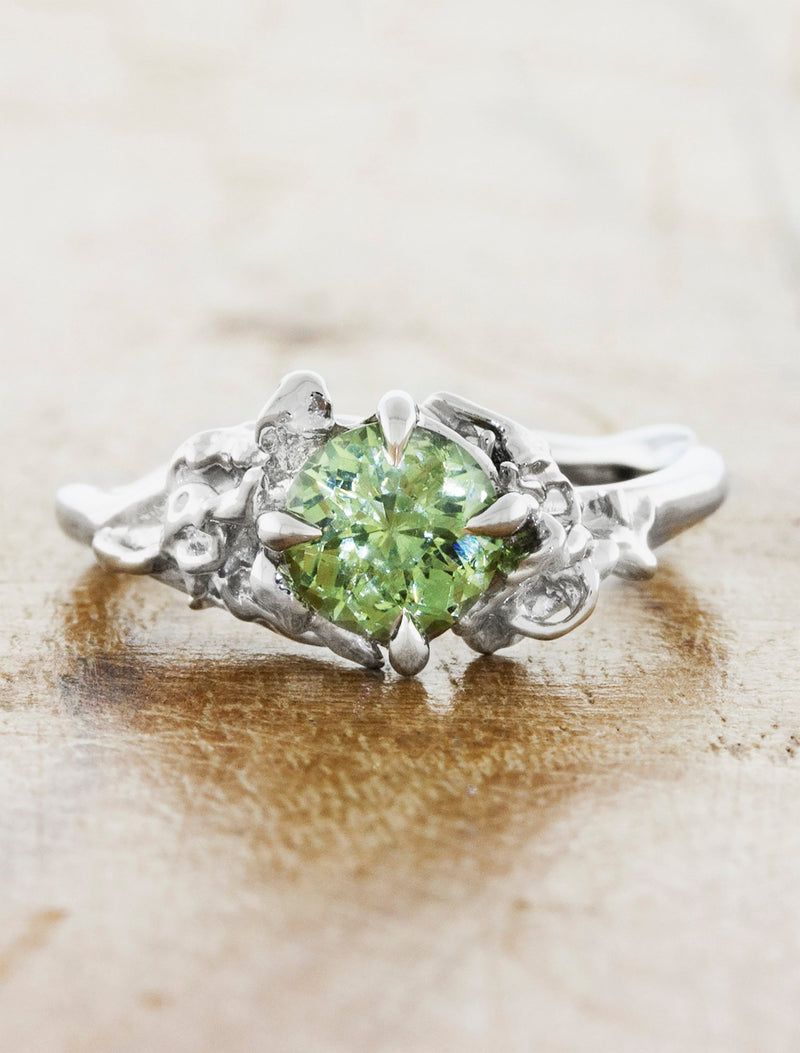 caption:Shown in platinum with green sapphire