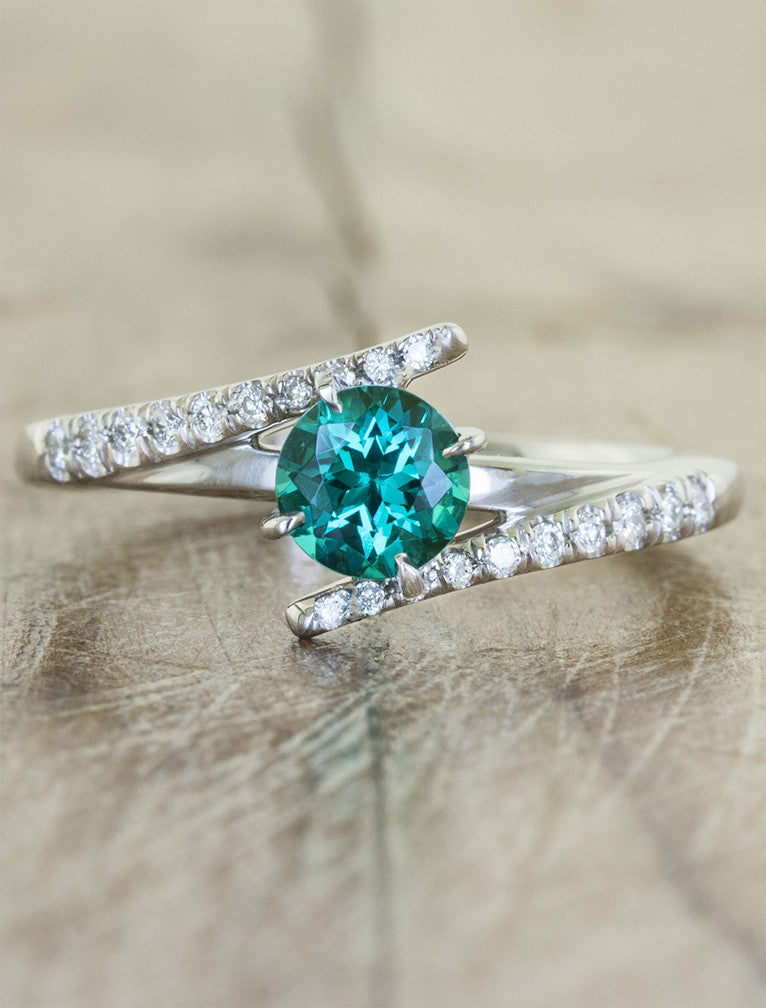 caption:Customized with round green emerald in platinum