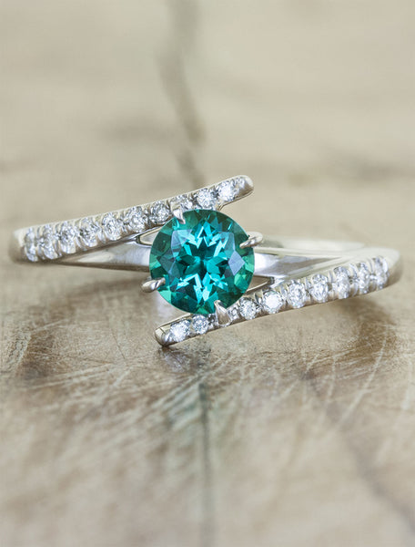 caption:Customized with a cultured green emerald 