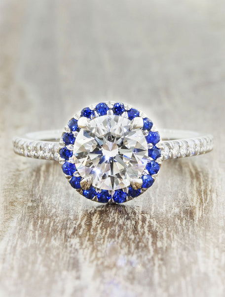 Round halo engagement ring. caption:Customized with a sapphire halo