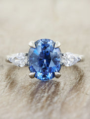caption:Shown here with a blue sapphire center stone