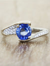 caption:Shown with blue sapphire center in platinum
