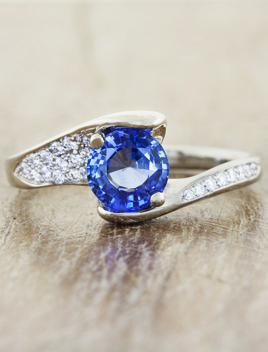 caption:Shown with blue sapphire center in platinum